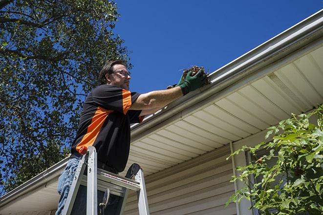 gutter being repaired with a ladder and tools in Cazenovia, IL